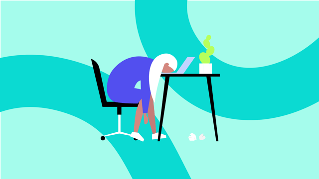 A frustrated employee with their head on a desk. They are sitting in a chair at a desk with a laptop and a plant.