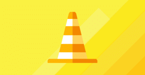 Article image for 20 constructive feedback examples for performance reviews -- a traffic cone on yellow background